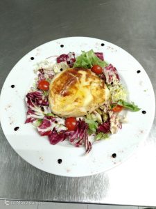 Grilled alpine cheese in a potato crust with salad